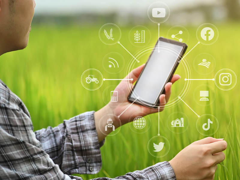 Farmer with mobile phone and social media icons